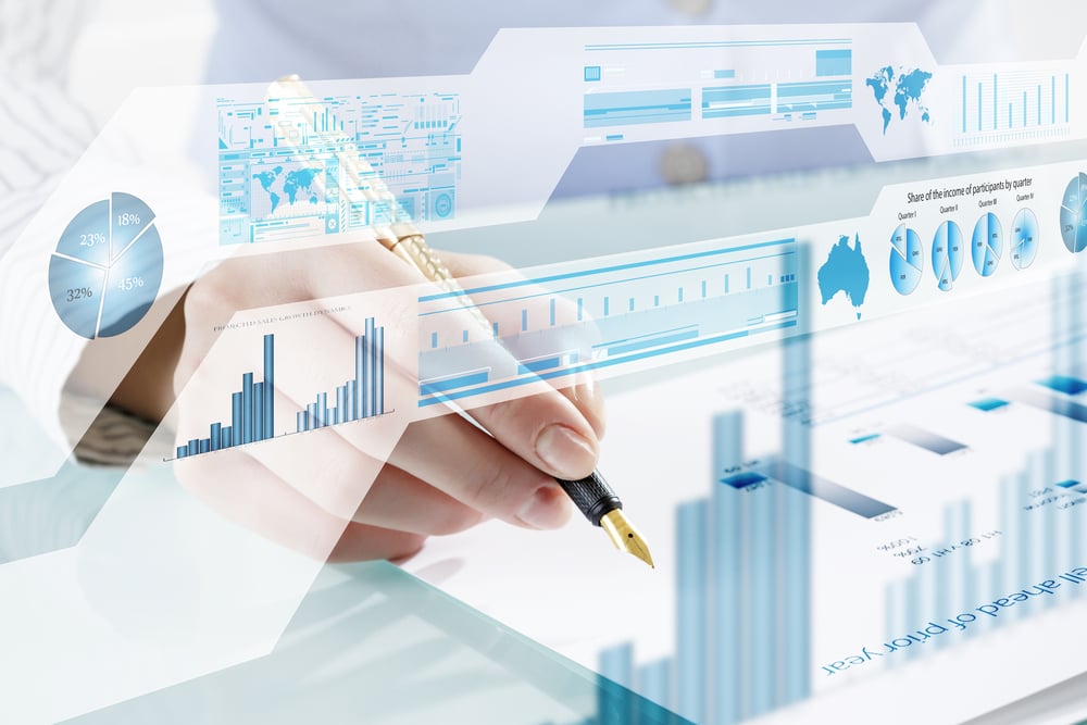 Businessman hand writing with pen and digital business infographs Businessman hand writing with pen and digital business infographs