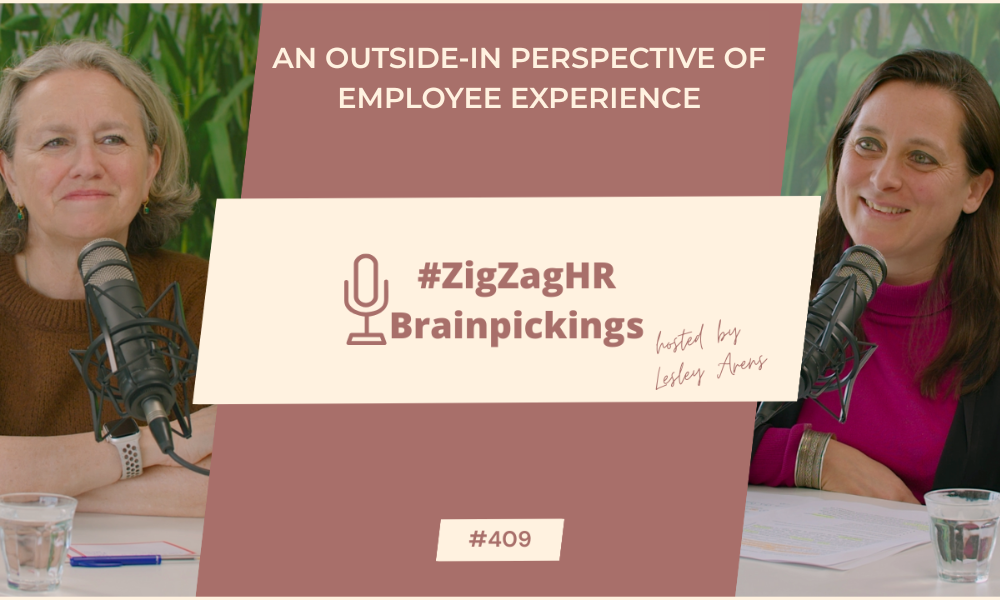 odcast promotional image for the #ZigZagHR Brainpickings episode hosted by Lesley Arens. The image features two women sitting at a table with microphones, engaged in a conversation. The background shows lush green plants. The central text reads, 